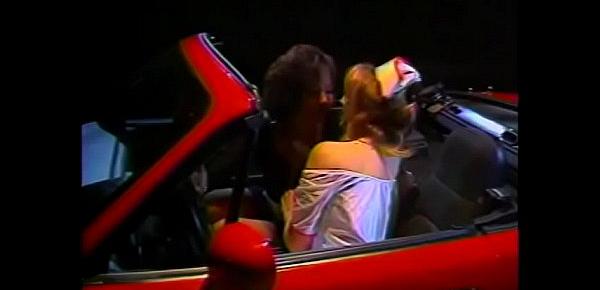  Redhead whore in a nurse costume licks pussy of a gorgeous brunette in the salon of a red convertible
